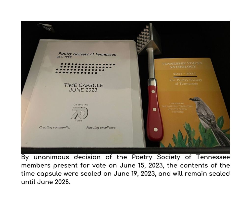 Contents of the Time Capsule inside an open container. A binder with various papers, a copy of the most recent edition of Tennessee Voices and a meat tenderizer.